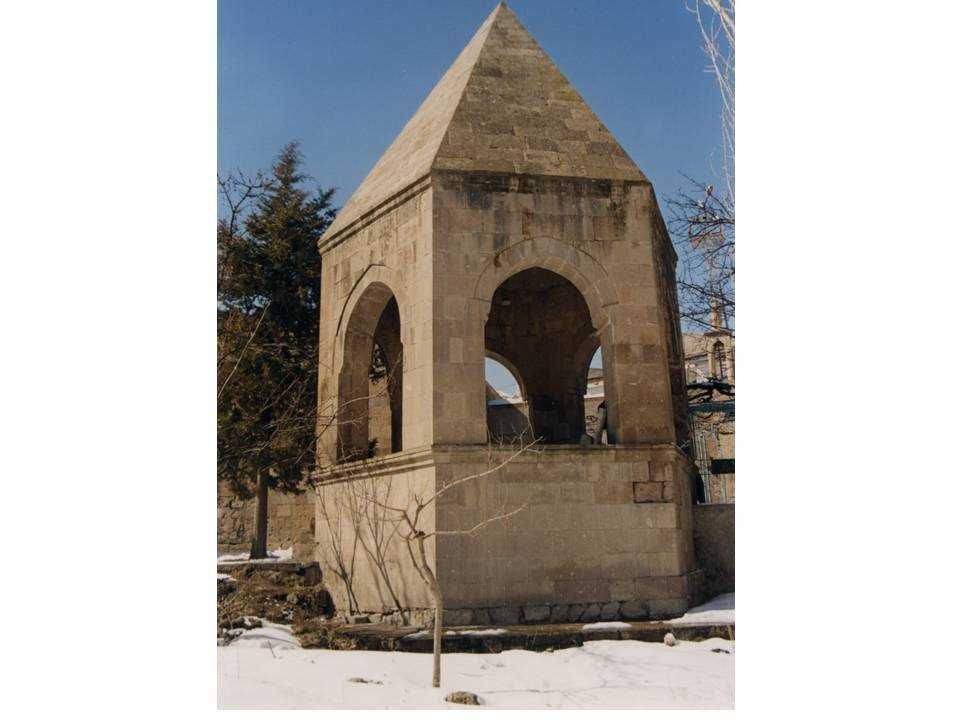 Altıgen planlı baldaken türbe; araları açık bırakılmış sivri kemerler.